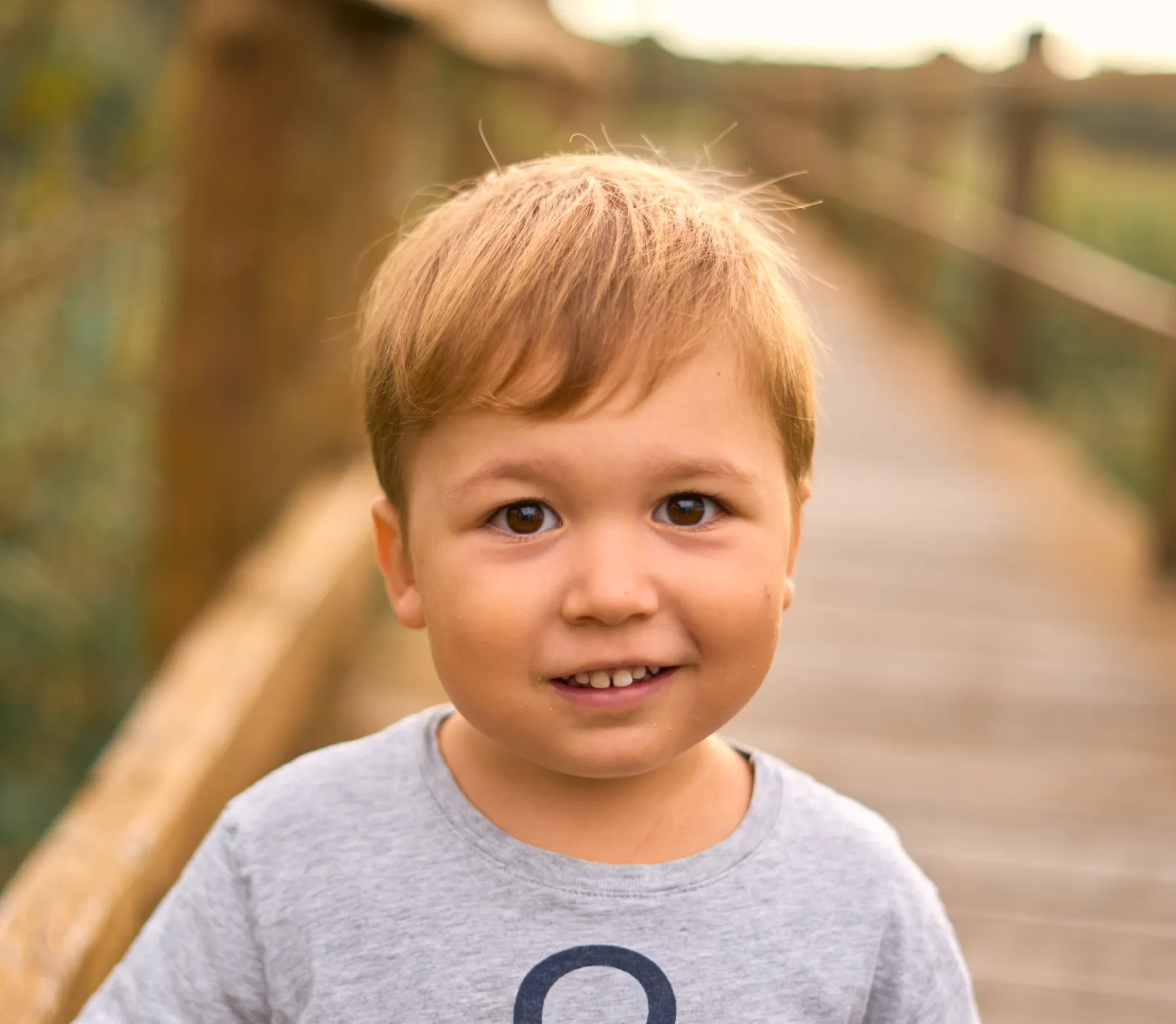 Child portrait on nature boardwalk at sunset in Zadar